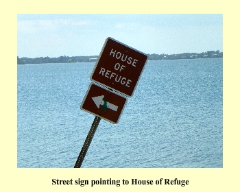 Street sign pointing to House of Refuge